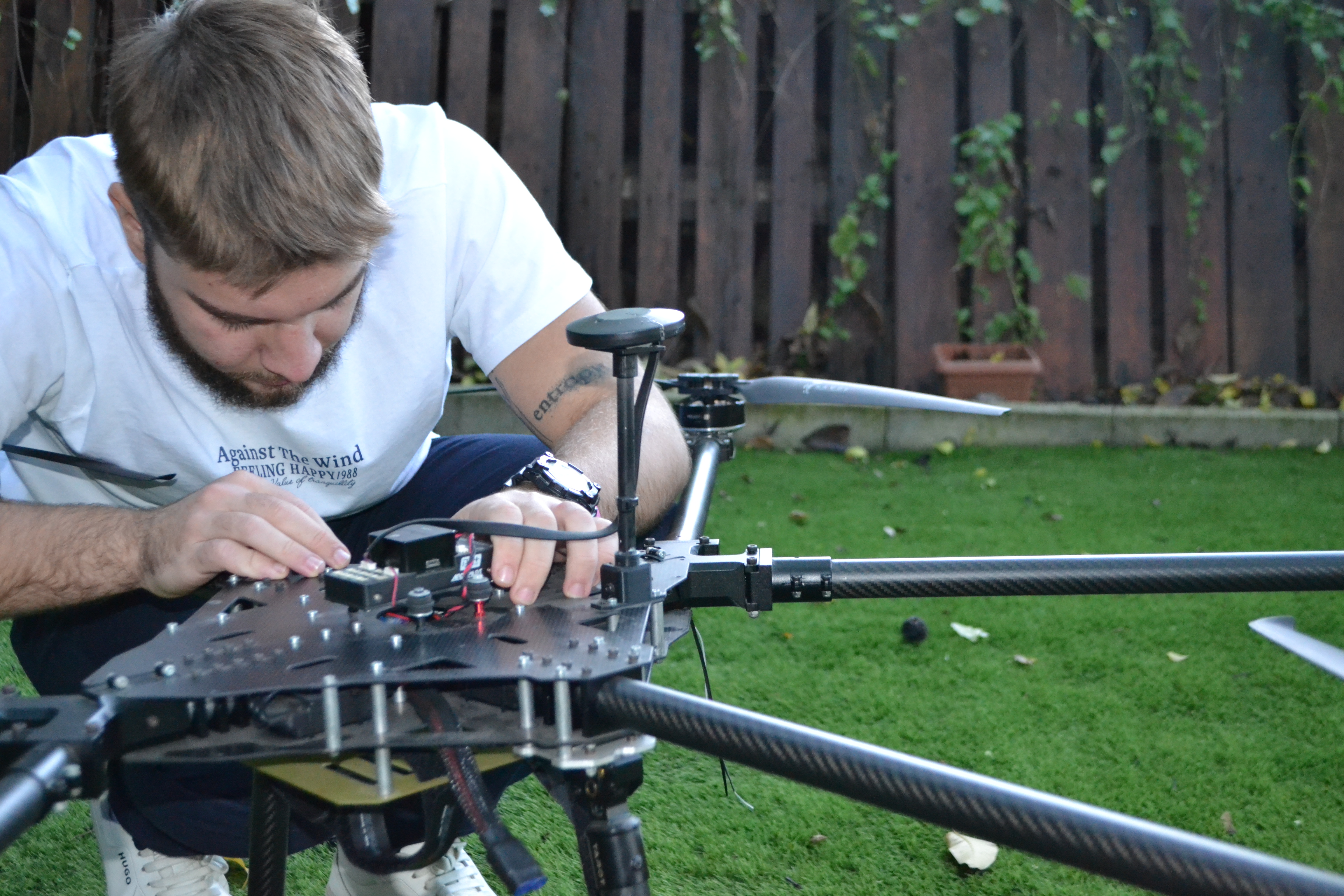 Mario assembling the Agri-pHLy drone frame outdoors